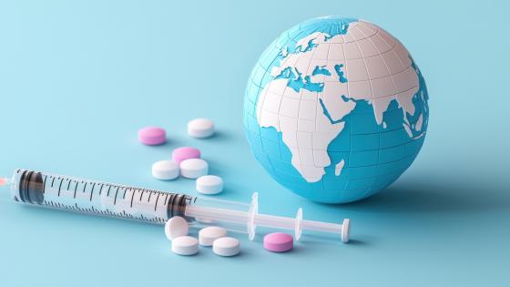 Globe next to tablets and syringe