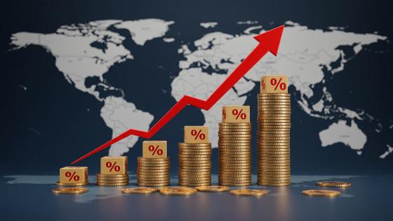 Stacks of coins with percentage blocks and a red arrow over a world map background