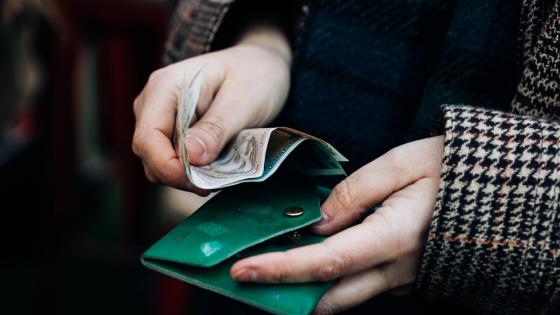 Woman taking money out of purse