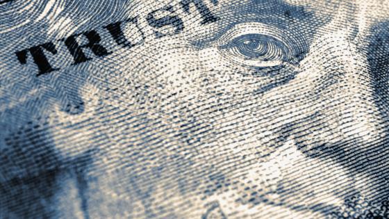 US 100 dollar note with the word "trust" written on on it