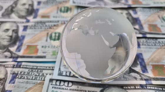Glass globe on top of US dollar bills