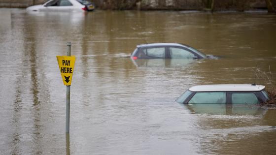 Abandoned Cars Submerged In Flood Water In Parking Lot In Oxfordshire UK
